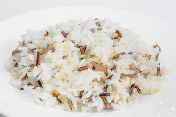 Cooked jasmine rice in a white plate. white background, high-calorie food
