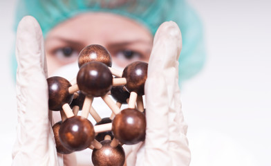 Woman holding molecule.
