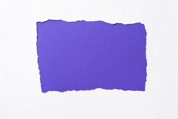 purple colorful background in white torn paper hole