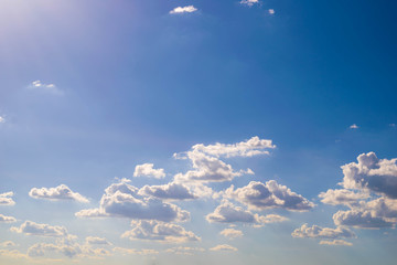 The sky is blue, the white clouds float in a beautiful view, the sun shines down on the clouds.