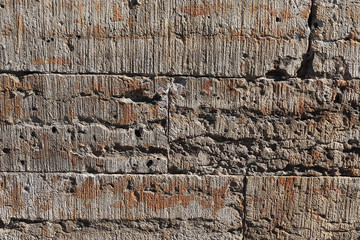 Old stone wall with cracks, natural concrete background, old natural texture of an ancient stone. It is used for decoration of buildings and embankments, a wonderful background for the desktop 