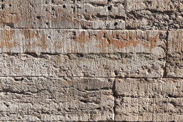 Old stone wall with cracks, natural concrete background, old na of an ancient stone. It is used for decoration of buildings and embankments, a wonderful background for the desktop and for photo design