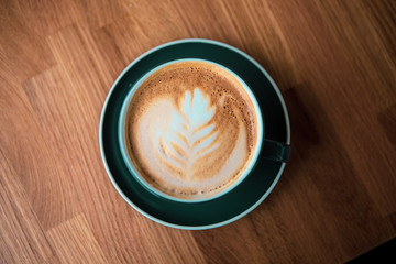 cup of coffee on wooden table