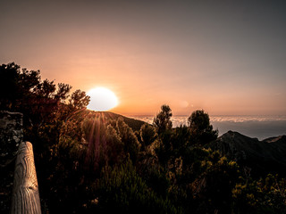 Romantic sunrise from the mountain above the clouds
