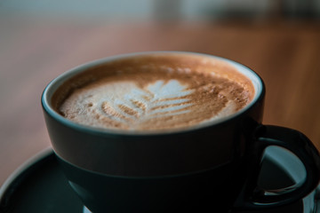 cup of coffee on wooden table