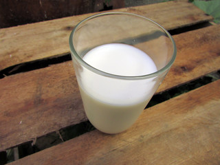 Glass of milk on wooden table