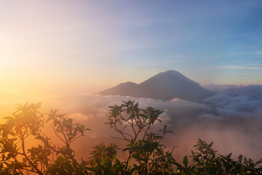 Mounts Abang and Agung during sunrise, view from Batur volcano on Bali Island, Indonesia