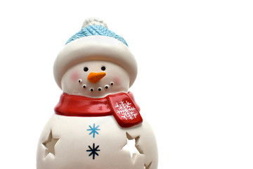 The figure of a ceramic snowman on an isolated white background. Christmas home decor, candle holder. Part of the image. Place for text