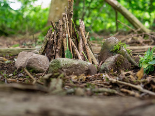 Small fire place in a forest. Assembled and ready to be set on fire. Camp preparation, tourism.