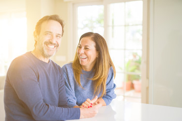 Romantic middle age couple sitting together at home
