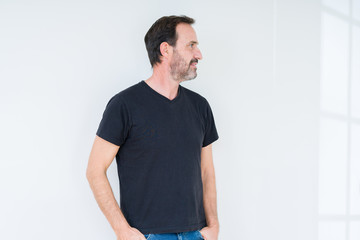 Fototapeta premium Senior man over isolated background looking to side, relax profile pose with natural face with confident smile.