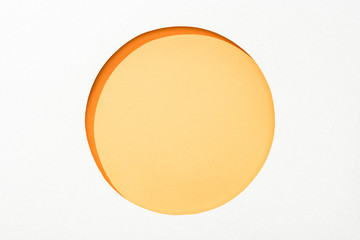 cut out round hole in white paper on yellow colorful background