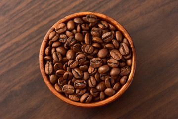 Coffee bens bowl on wooden background