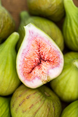 Bunch of green figs on a wooden platter