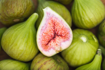 Bunch of green figs on a wooden platter
