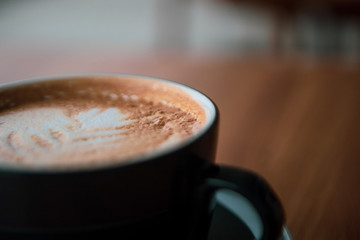 cup of coffee on wooden table