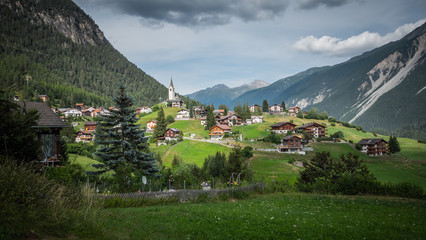 Fototapeta na wymiar Typical Swiss village in a valley of the Swiss Alps in Switzerland