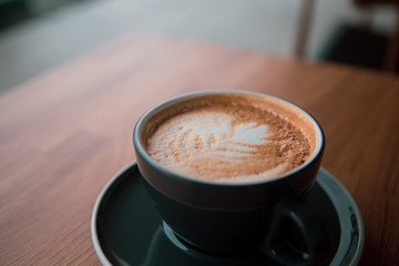 cup of coffee on wooden table