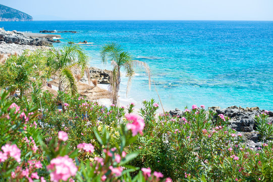 Rocky beach and crystal turquoise water of Ionian Sea in Albania. Calm and relaxing view