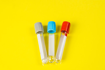 Bottles for samples used in hospitals or medicine for blood samples in a laboratory on a yellow background