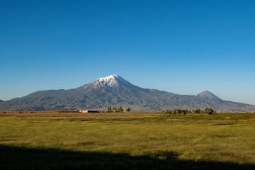 Fototapeta premium Breathtaking view of Mount Ararat, Agri Dagi, the highest mountain in the extreme east of Turkey accepted in Christianity as the resting place of Noah's Ark, a snow-capped and dormant compound volcano