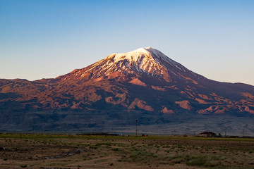 Fototapeta premium Breathtaking sunset on Mount Ararat, Agri Dagi, the highest mountain in the extreme east of Turkey accepted in Christianity as the resting place of Noah's Ark, snow-capped and dormant compound volcano