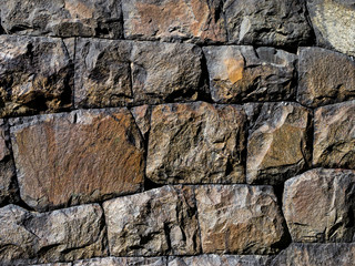 Rocks in different sizes and colors build up an old stone wall that creates a nice background pattern.