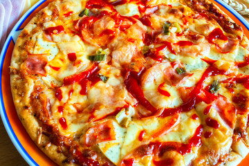 sausage pizza and orphaned on a table