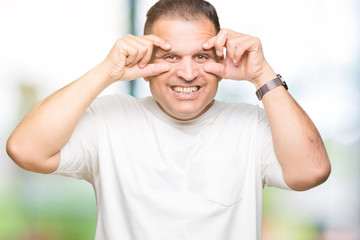 Middle age arab man wearig white t-shirt over isolated background Trying to open eyes with fingers, sleepy and tired for morning fatigue