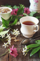 Decorative composition of vintage style: romantic tea drinking with jasmine tea