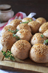 Crown sourdough bread buns with sesame and thyme garnish