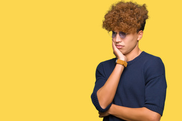 Fototapeta na wymiar Young handsome man with afro wearing glasses thinking looking tired and bored with depression problems with crossed arms.