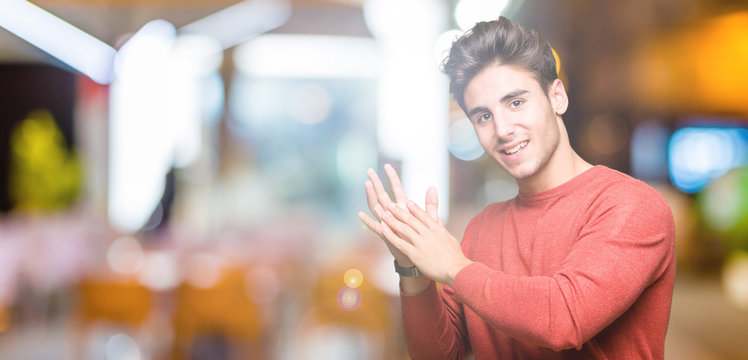 Young handsome man over isolated background Clapping and applauding happy and joyful, smiling proud hands together