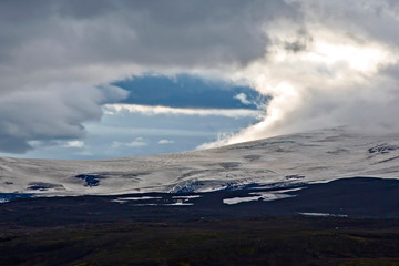 mountain landscape with contrasting clouds in Iceland.