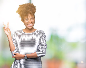 Beautiful young african american woman wearing glasses over isolated background smiling with happy...