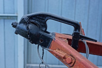 black iron hitch on a brown trailer on a gray background