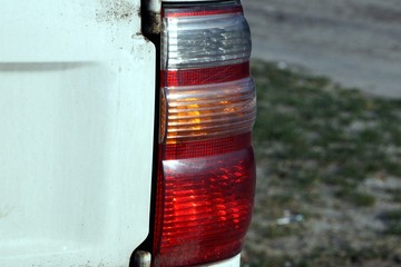large color dirty taillight on a white car