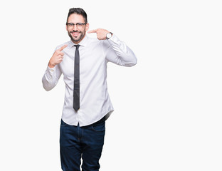 Young handsome business man wearing glasses over isolated background smiling confident showing and pointing with fingers teeth and mouth. Health concept.