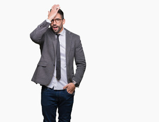 Young handsome business man over isolated background surprised with hand on head for mistake,...