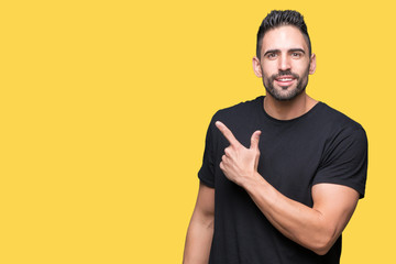 Fototapeta premium Young handsome man over isolated background cheerful with a smile of face pointing with hand and finger up to the side with happy and natural expression on face