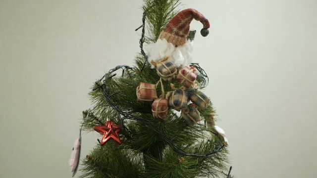 Happy family decorating a Christmas tree with boubles in the living-room