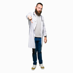 Young blond doctor man with beard wearing medical coat looking unhappy and angry showing rejection and negative with thumbs down gesture. Bad expression.