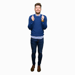Fototapeta premium Young handsome bussines man excited for success with arms raised celebrating victory smiling. Winner concept.