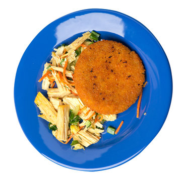 fishcake with soy asparagus and carrots, cucumbers and dilll. fish cutlet on a plate isolated. cutlet with vegetables top view