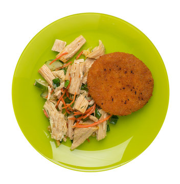 fishcake with soy asparagus and carrots, cucumbers and dilll. fish cutlet on a plate isolated. cutlet with vegetables top view