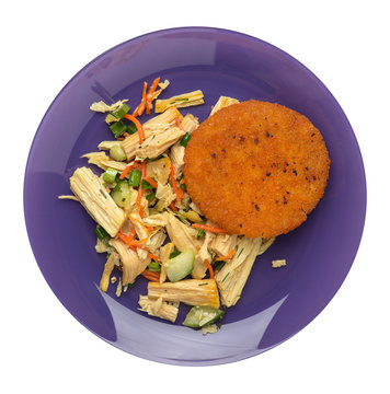 fishcake with soy asparagus and carrots, cucumbers and dilll. fish cutlet on a plate isolated. cutlet with vegetables top view