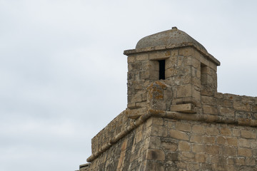 Fototapeta na wymiar Corner turret of historic 17th century stone fort in Vila do Conde, Portugal. Fort of John the Baptist / Joao Batista.
