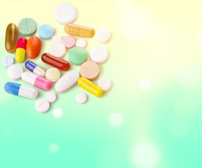 Colorful pills and tablets on background