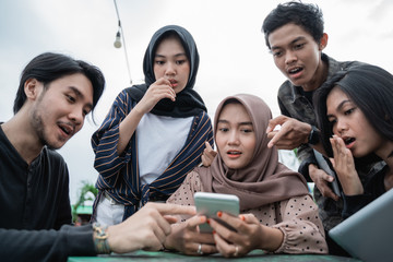 Asian young people happy looking a new smartphone