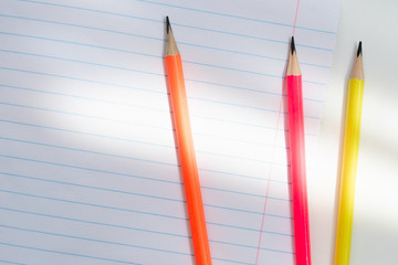 Back to school, education concept - colourful pencils close up and composition book on background...